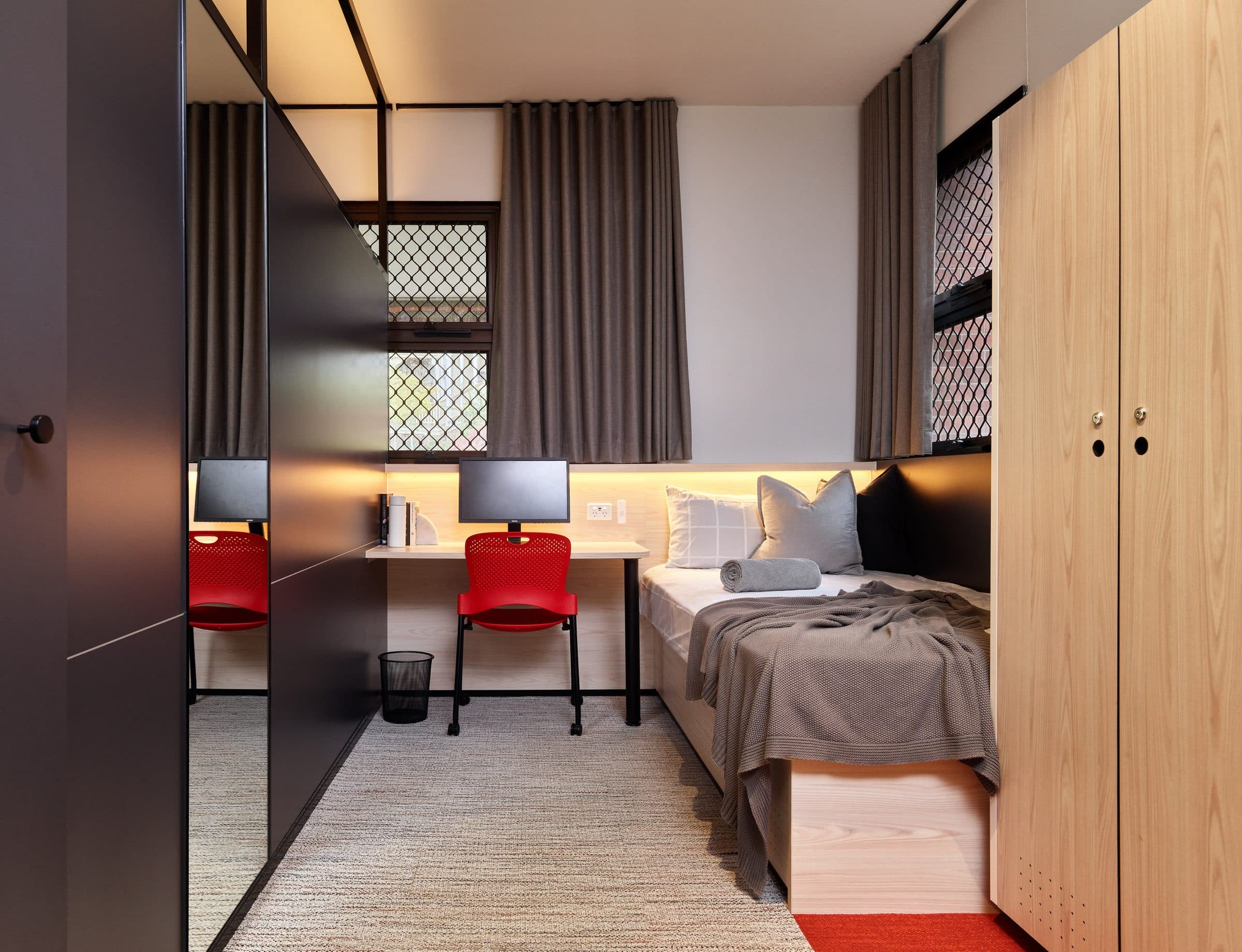 Boarder's room with built-in desk, wardrobe and bed.