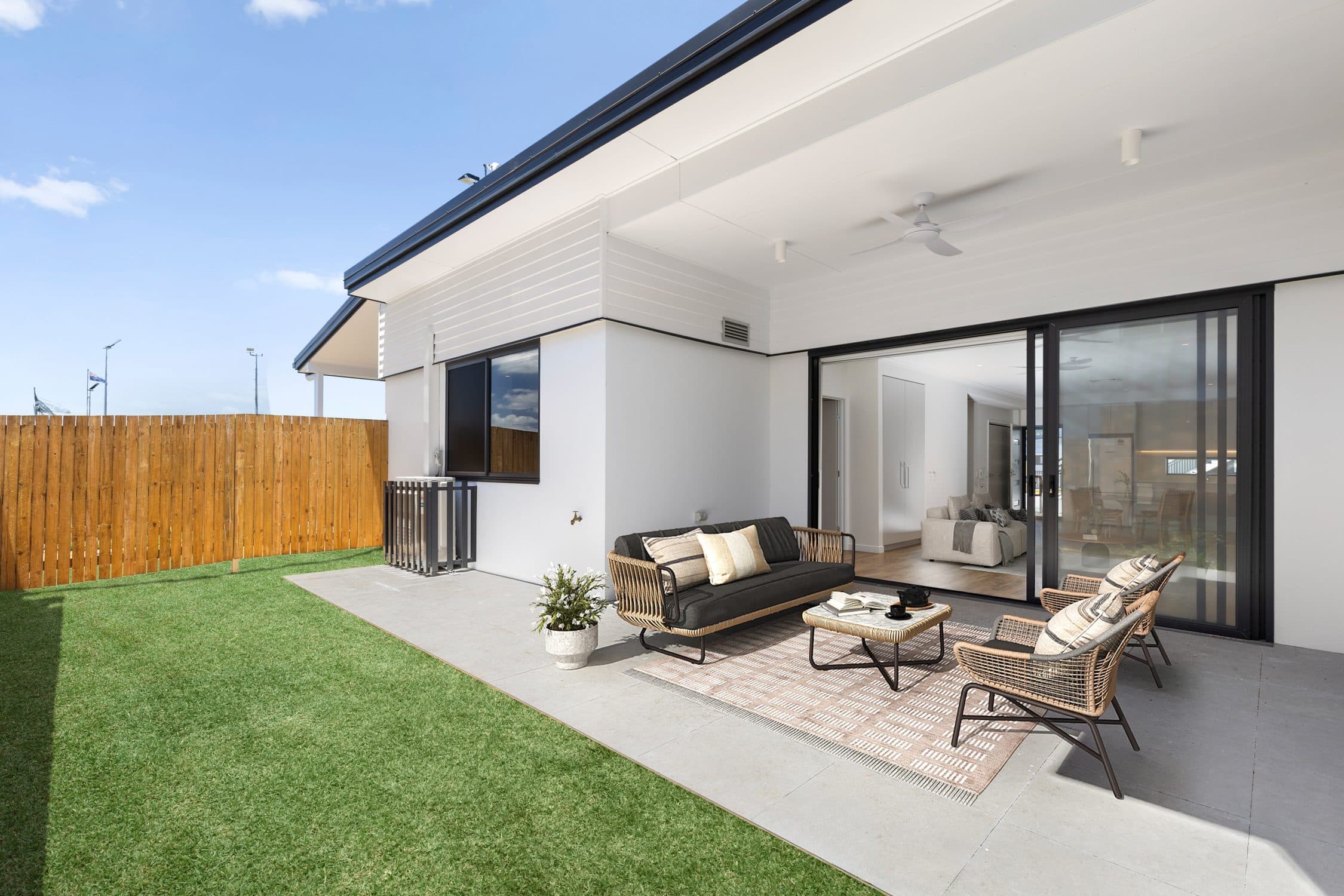 A ground floor unit opening onto its covered patio and lawn.
