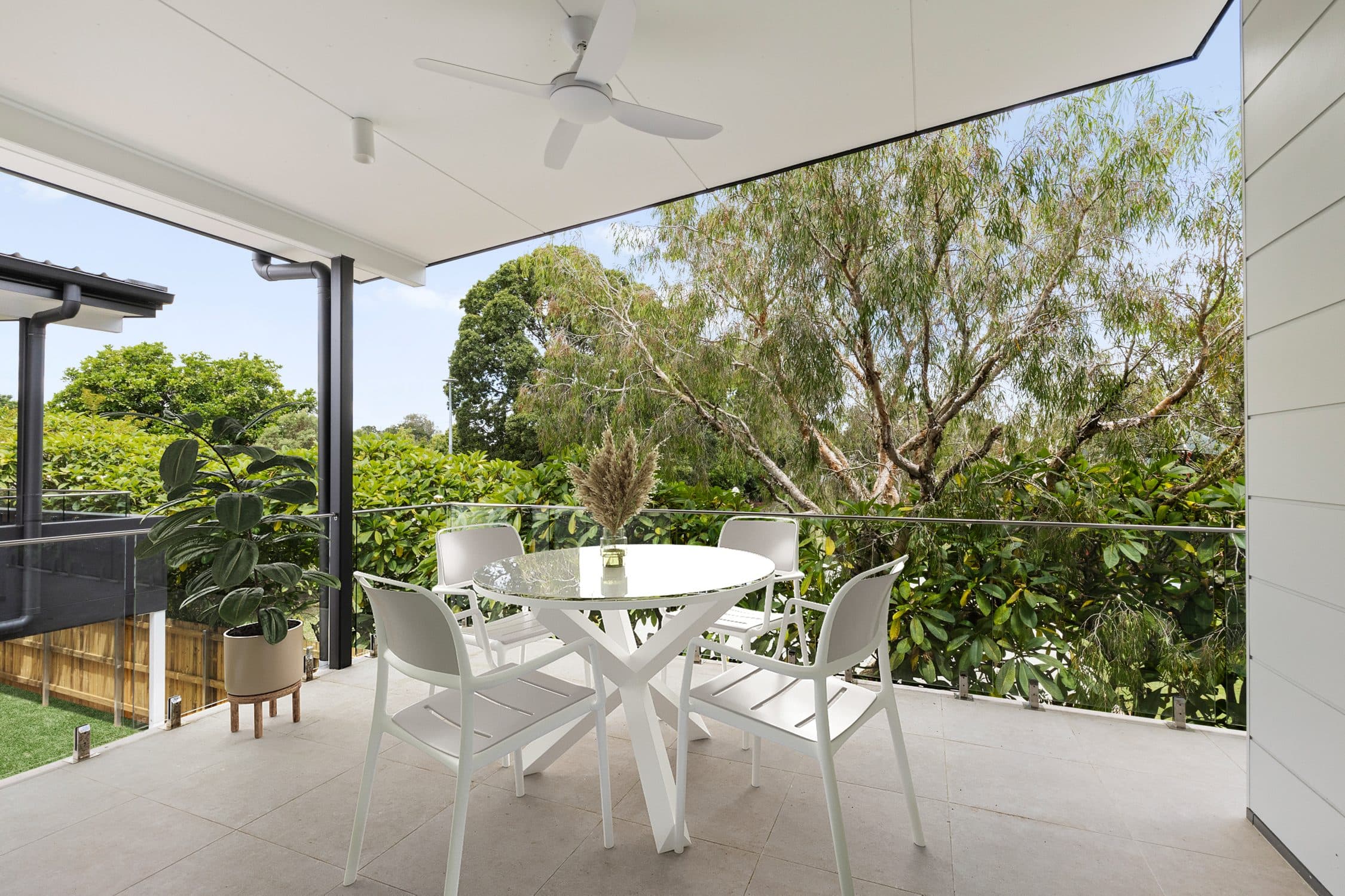 An upper level balcony looking into the established trees.