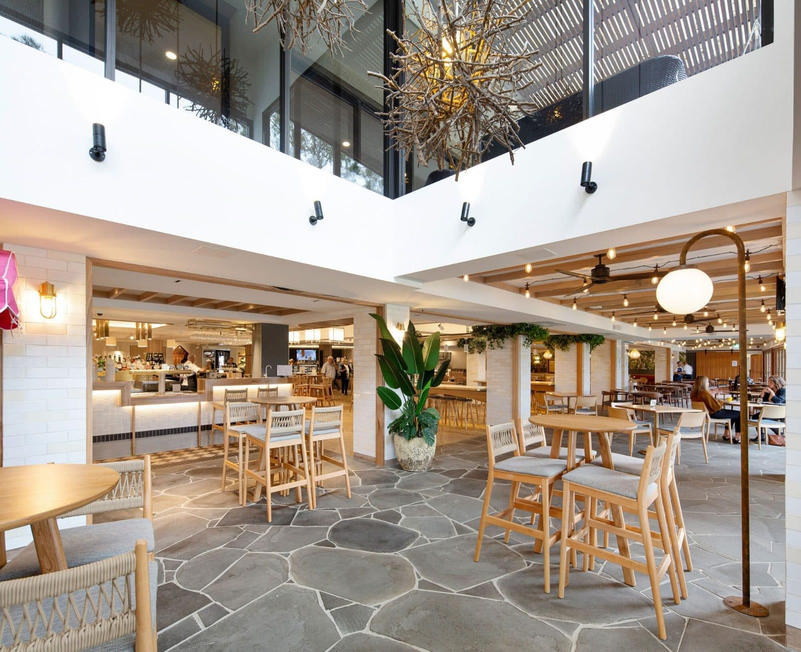 The lounge under the atrium, with timber ceiling battens and a feature pendant.