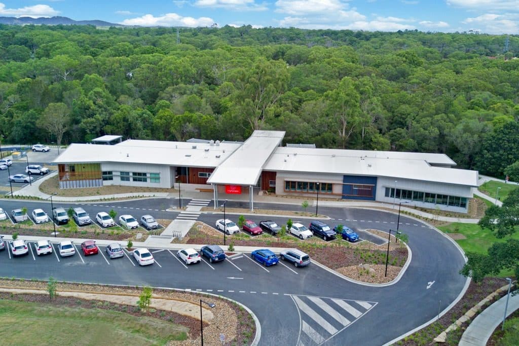 Aerial view of the centre and carpark set into bushland.