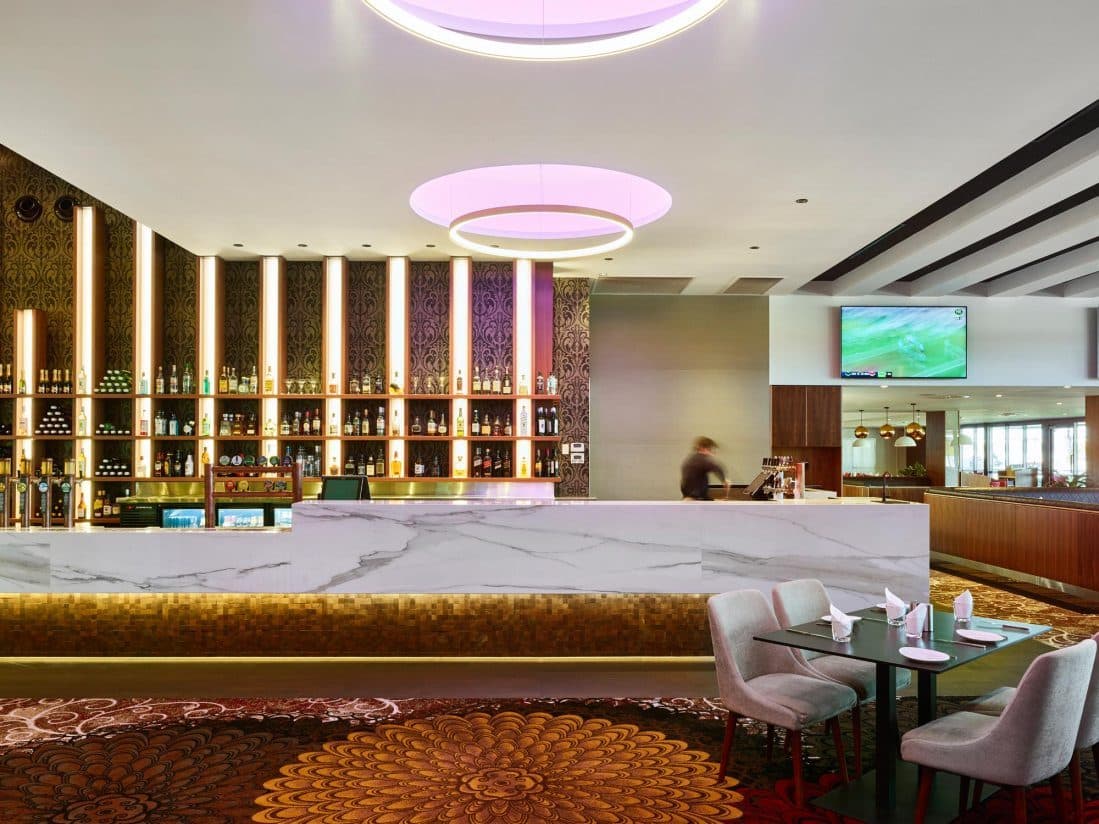 The main bar and dining area under circular lighting.