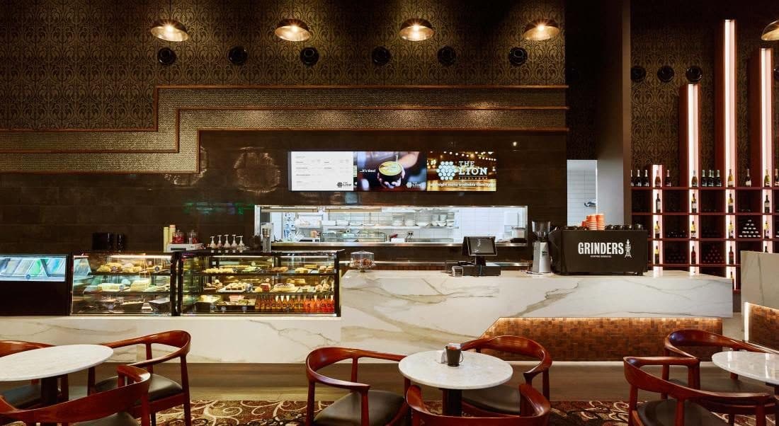 The cafe counter with display cabinets and marble bench.