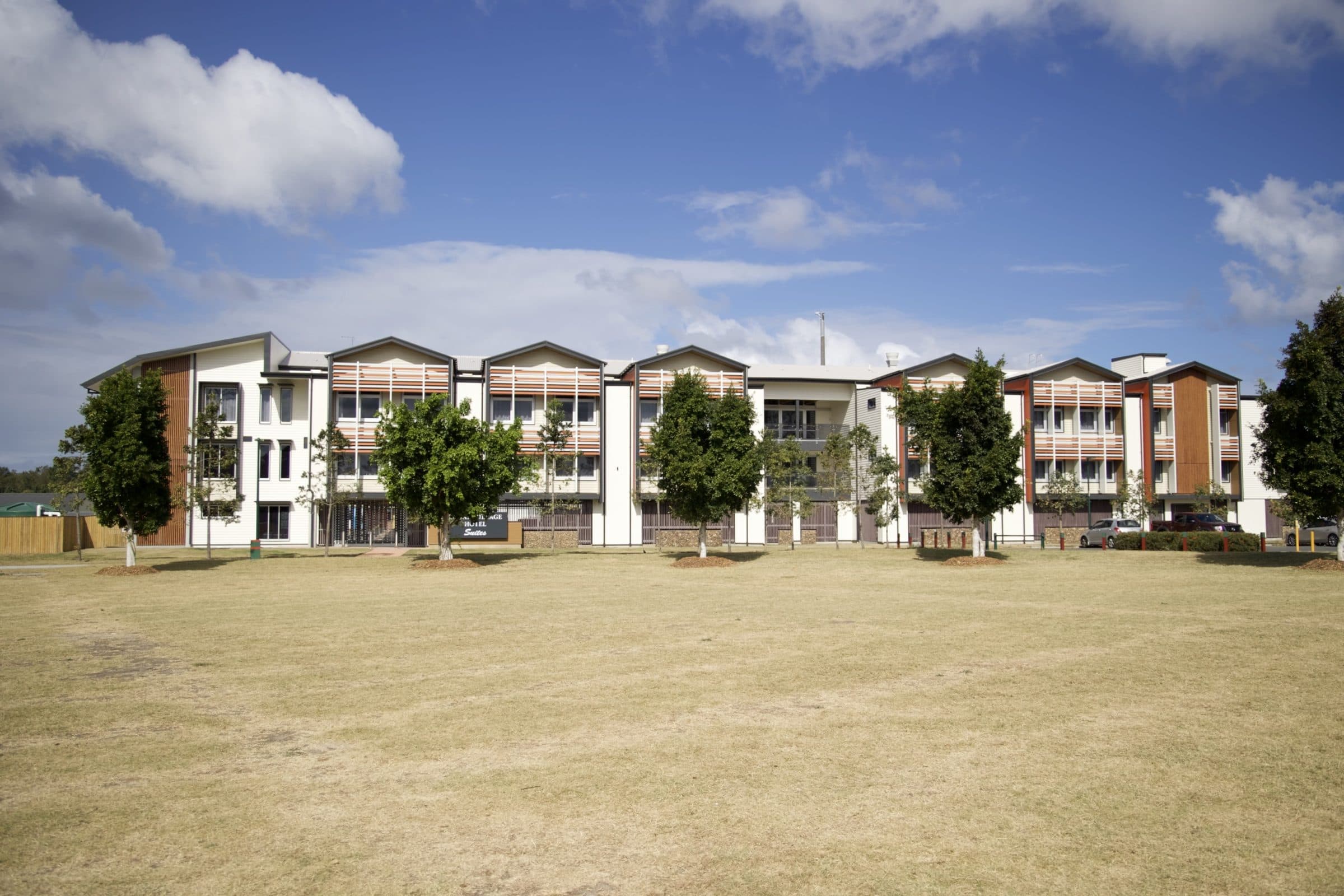 The full length of the motel from across the open lawn.
