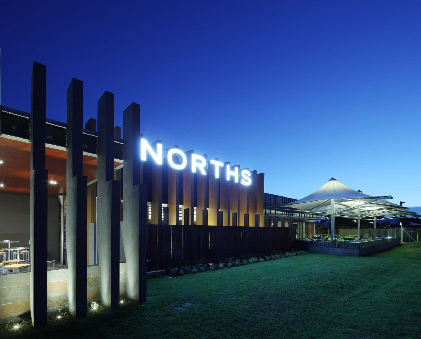 The club frontage lit at night.