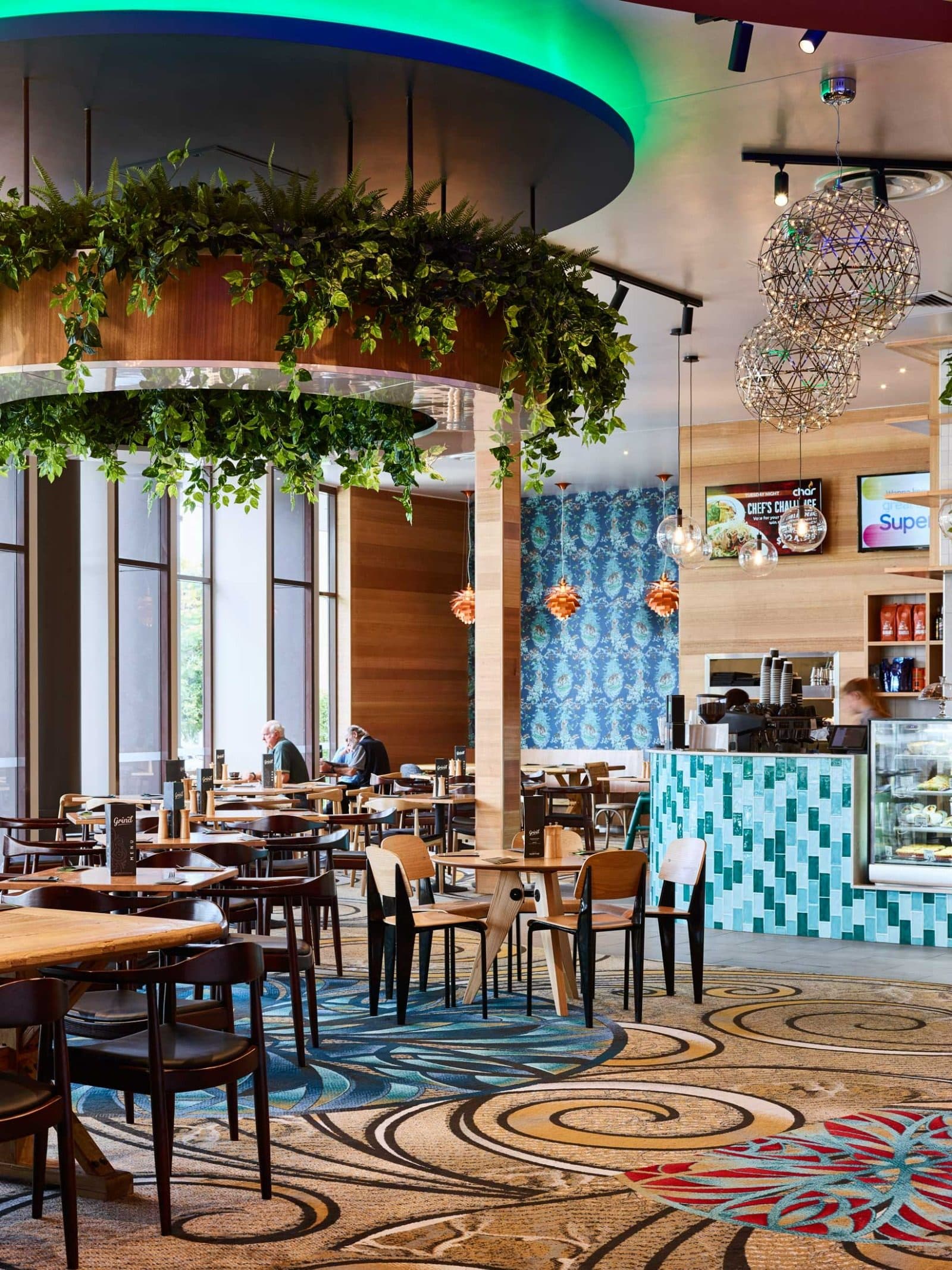 Cafe seating under a planted ring light.