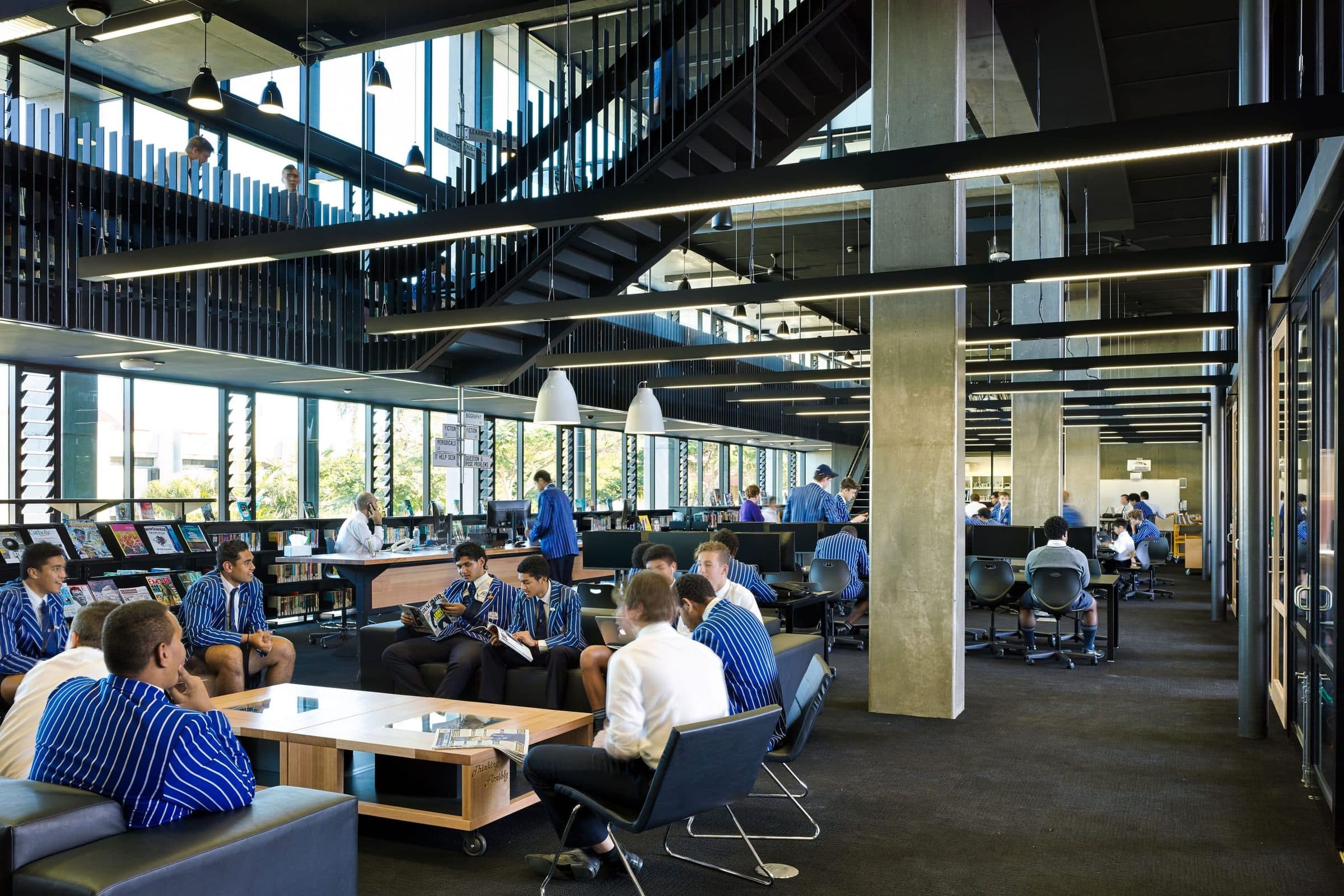 The library floor with study tables and stairs above.
