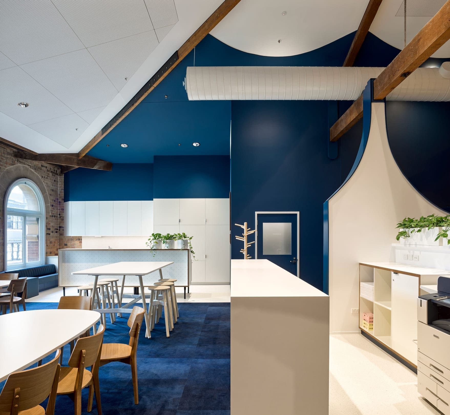 The staff kitchen and meeting area with arched windows.