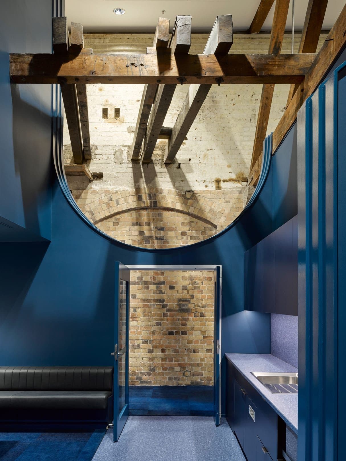 A doorway framed by the restored brickwork and a semi-circular wall.